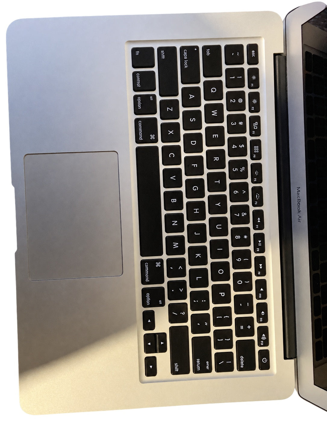 Actual Apple MacBook Air 13.3-inch 2015 keyboard and palm rest on white background