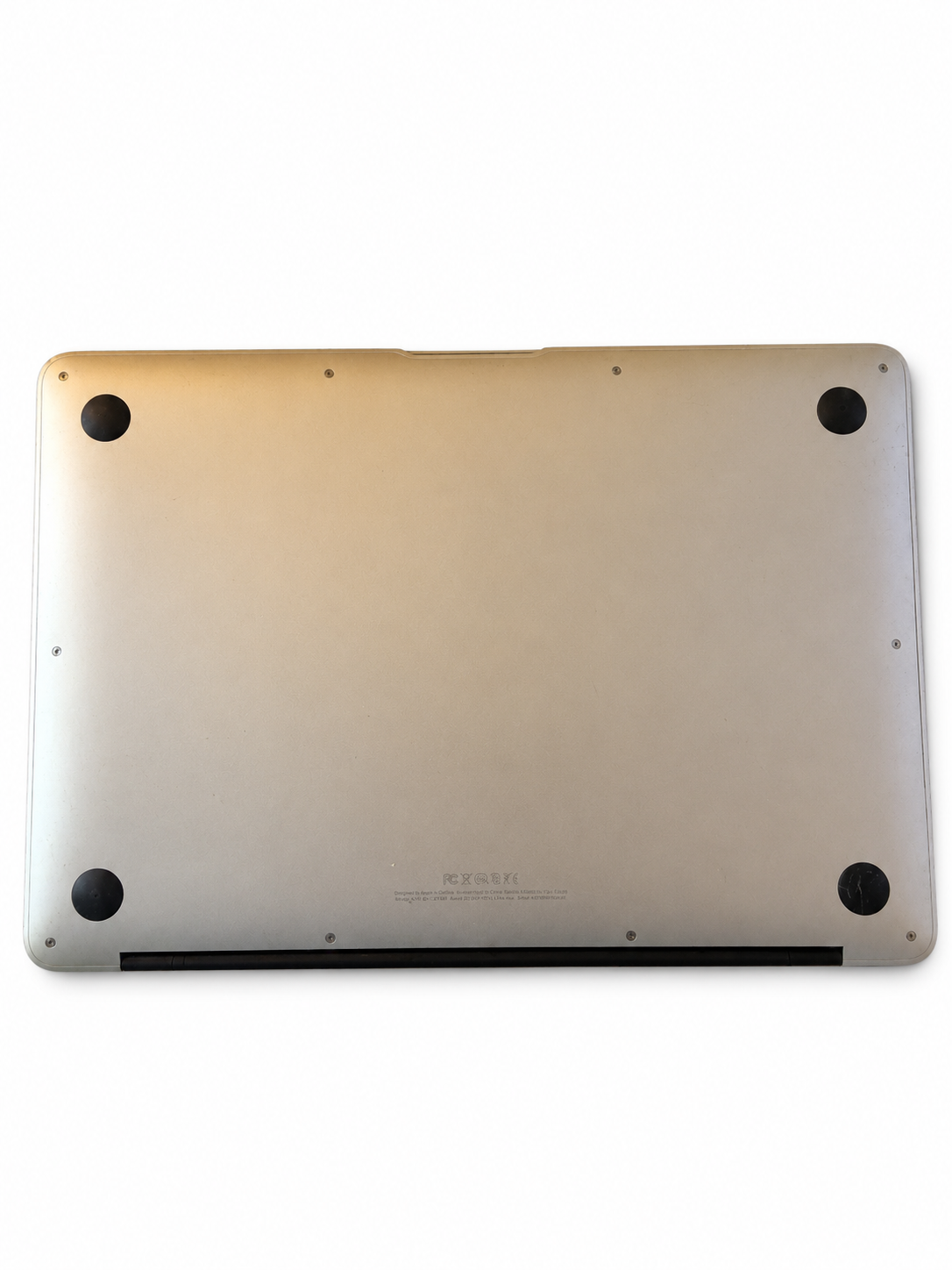 Actual Apple MacBook Air Early 2015 underside condition on white background