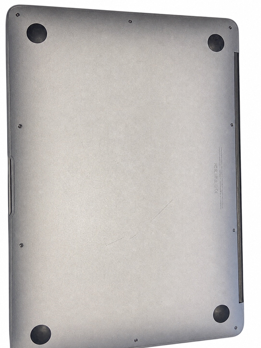 Actual Apple MacBook Air 13.3-inch 2015 underside on white background showing scratches